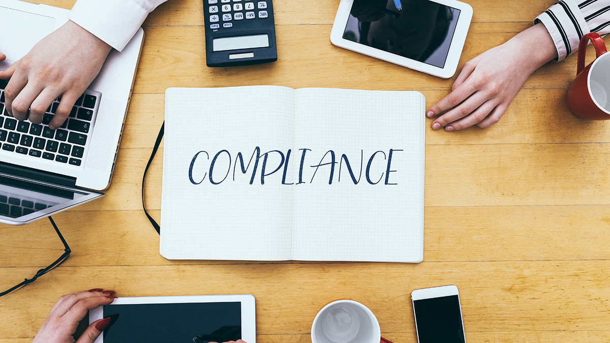 compliance-headline-on-paper-notebook-at-small-bus-1200